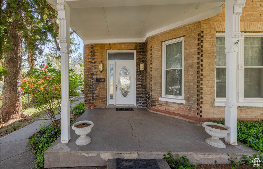 Entrance to property featuring covered porch