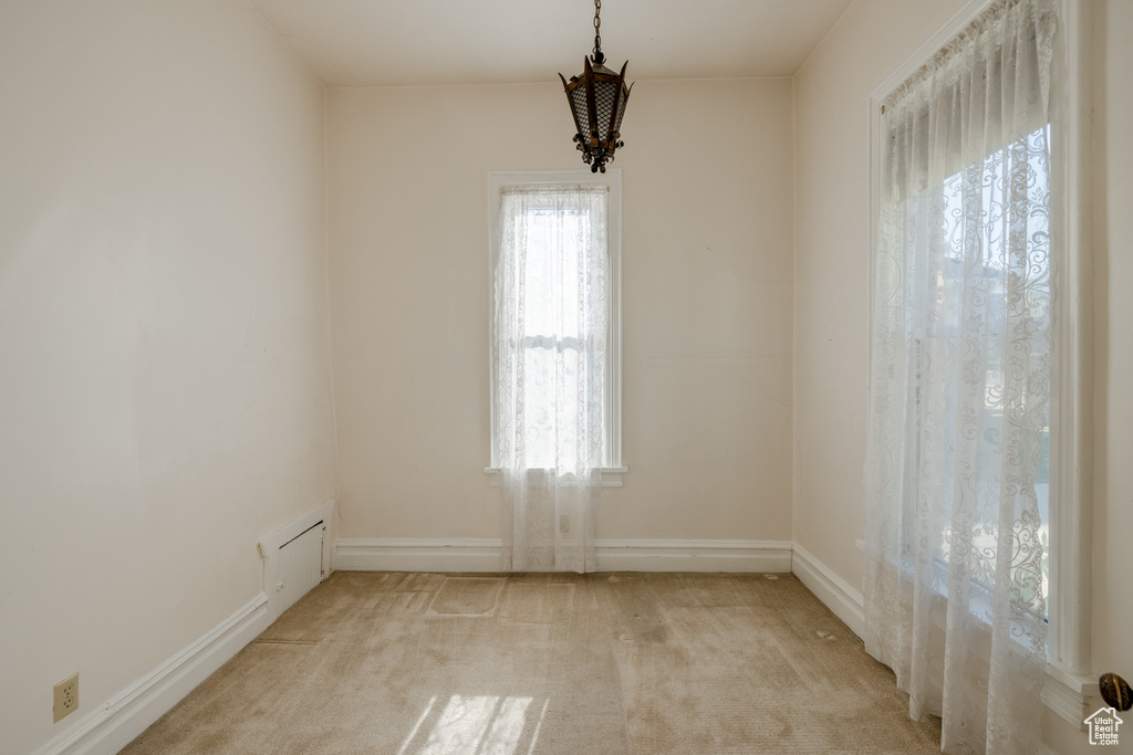 Carpeted empty room featuring a wealth of natural light