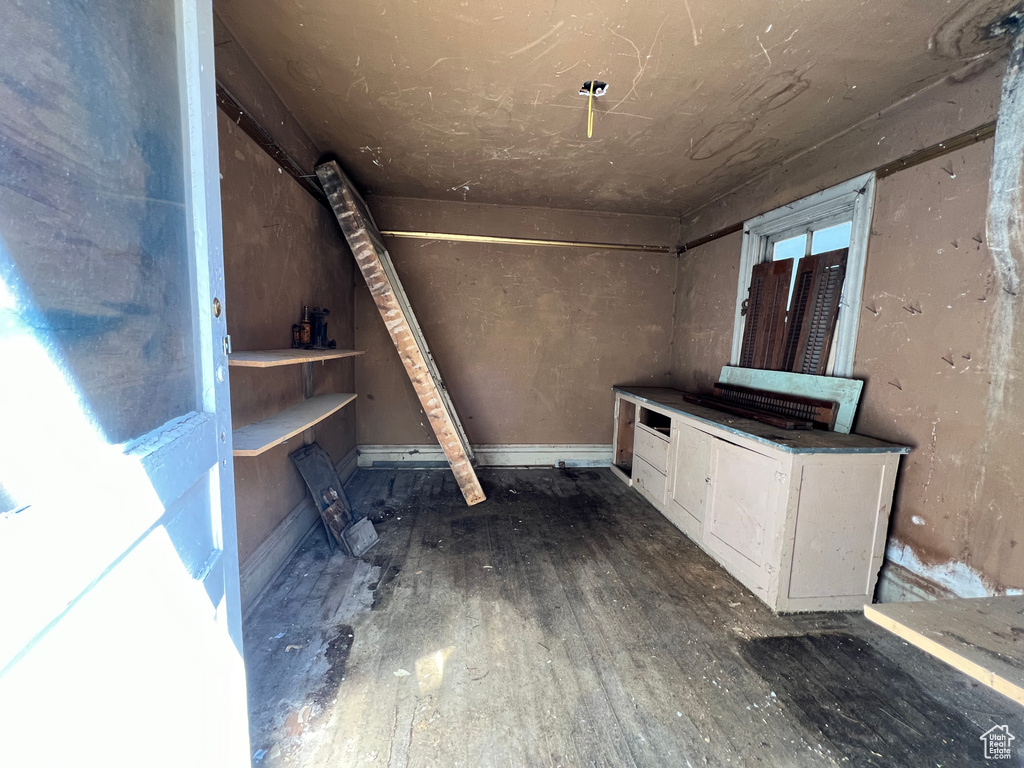 Basement with dark hardwood / wood-style flooring