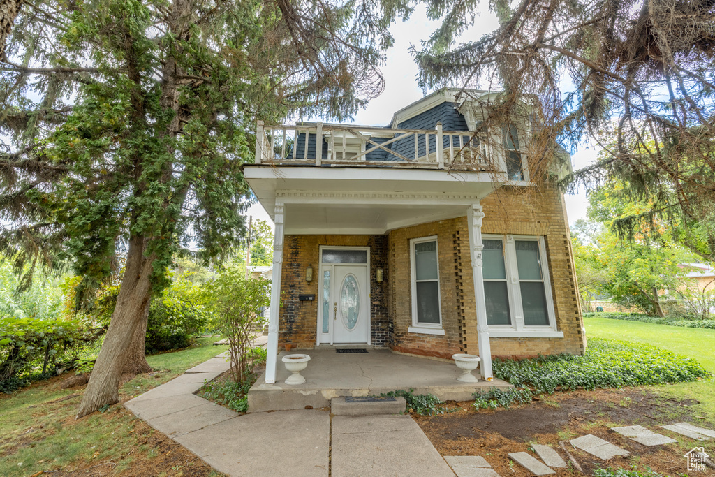 View of front of property with a balcony