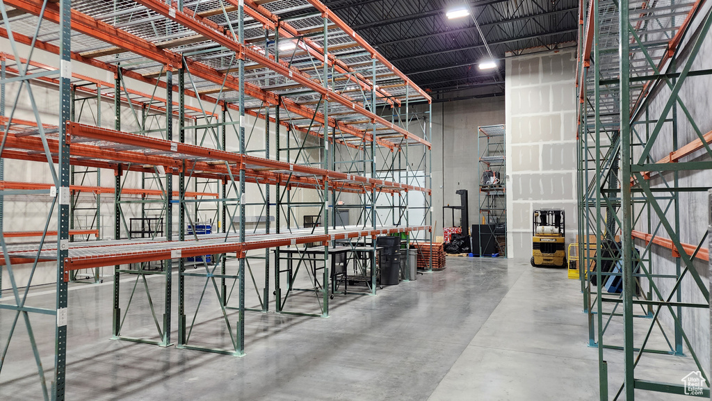 Misc room with a high ceiling and concrete floors