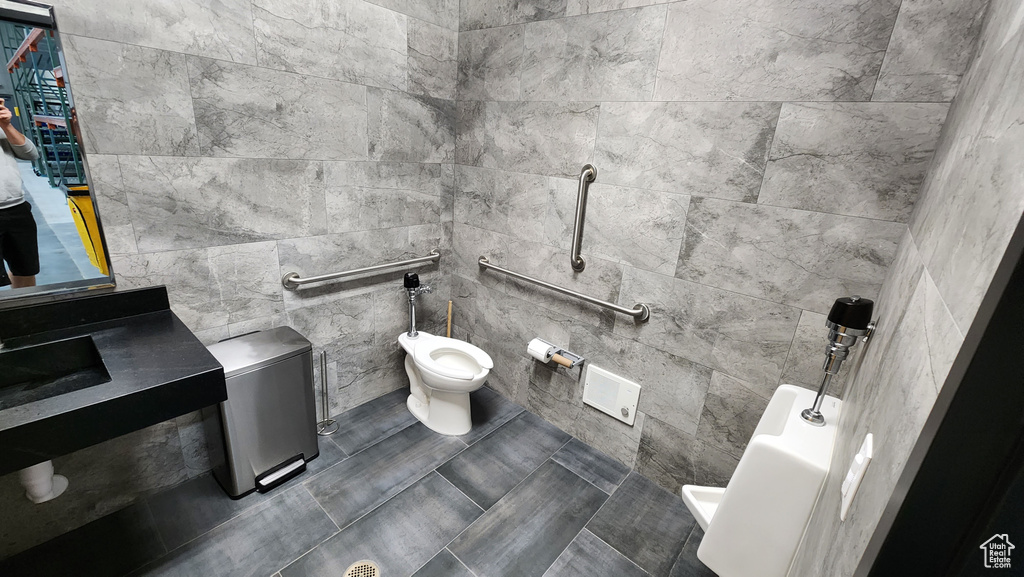 Bathroom with a bidet and tile walls