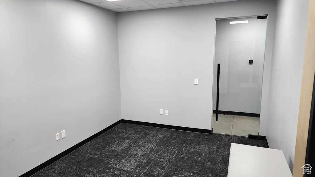 Unfurnished room featuring a drop ceiling