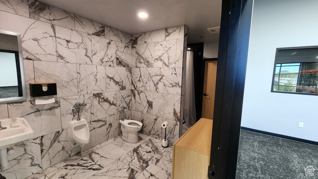 Bathroom with a bidet, a shower, and toilet