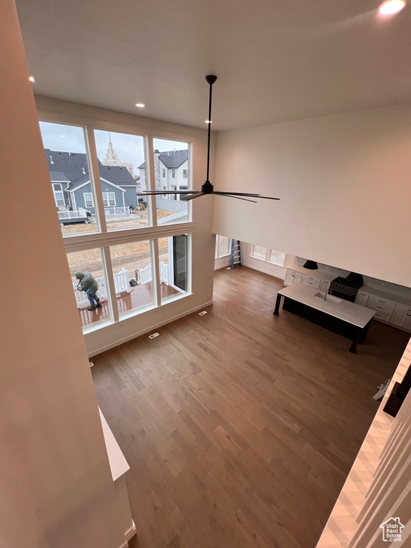 Unfurnished living room featuring hardwood / wood-style floors and ceiling fan