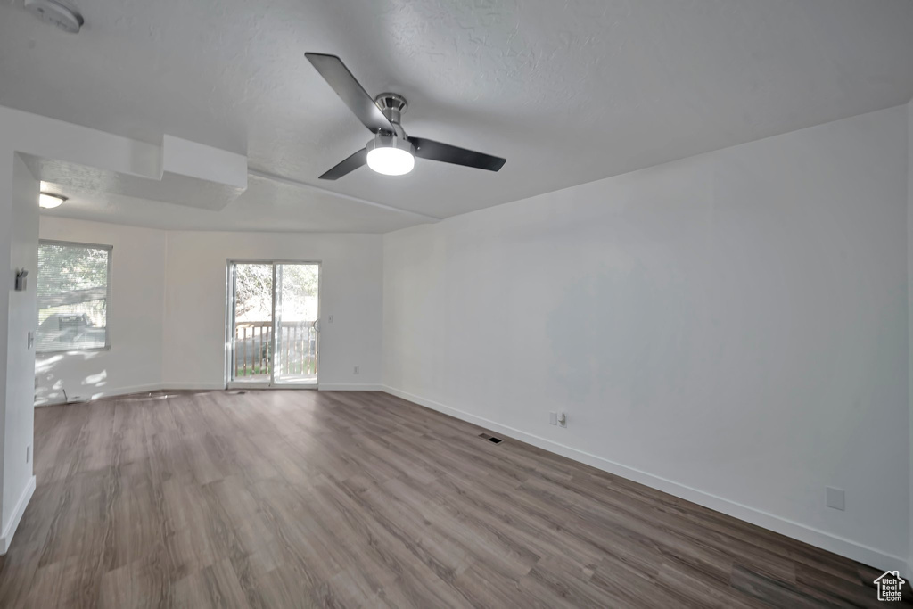 Spare room featuring hardwood / wood-style flooring, a textured ceiling, and ceiling fan