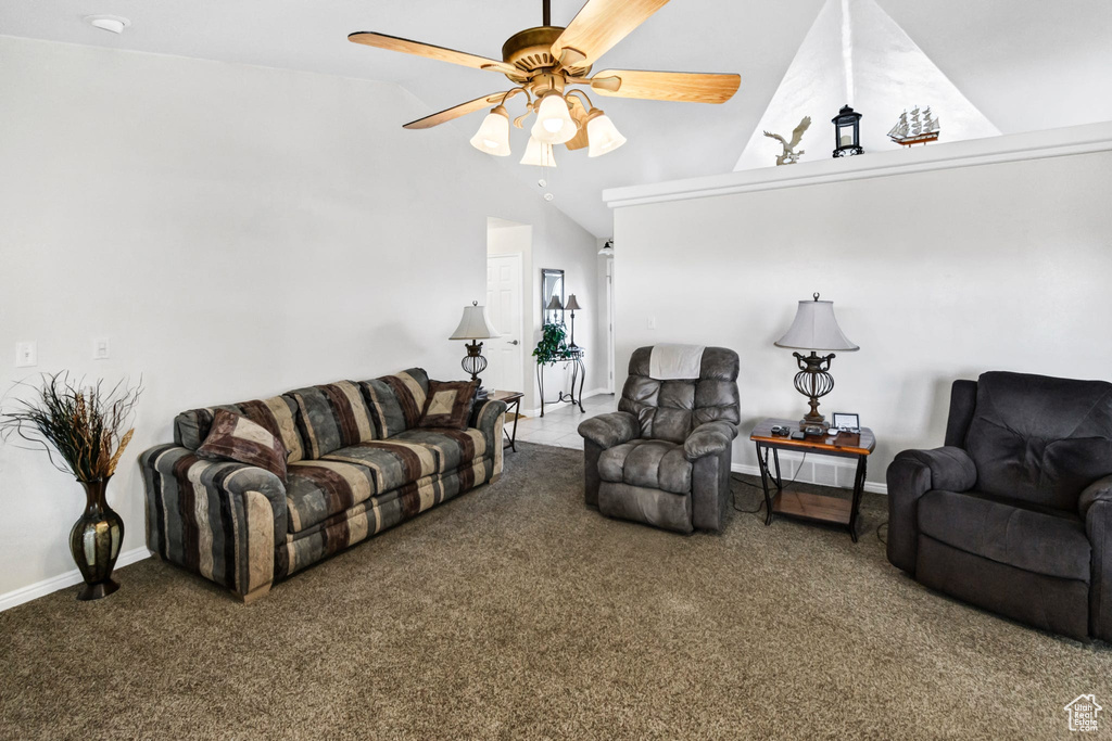 Carpeted living room featuring vaulted ceiling and ceiling fan