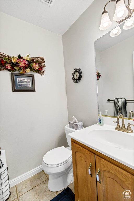 Bathroom with vanity, tile patterned floors, and toilet