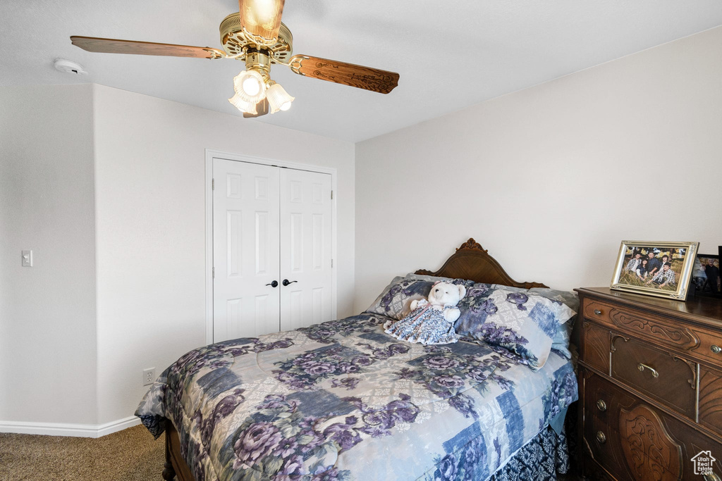 Bedroom with carpet floors, a closet, and ceiling fan