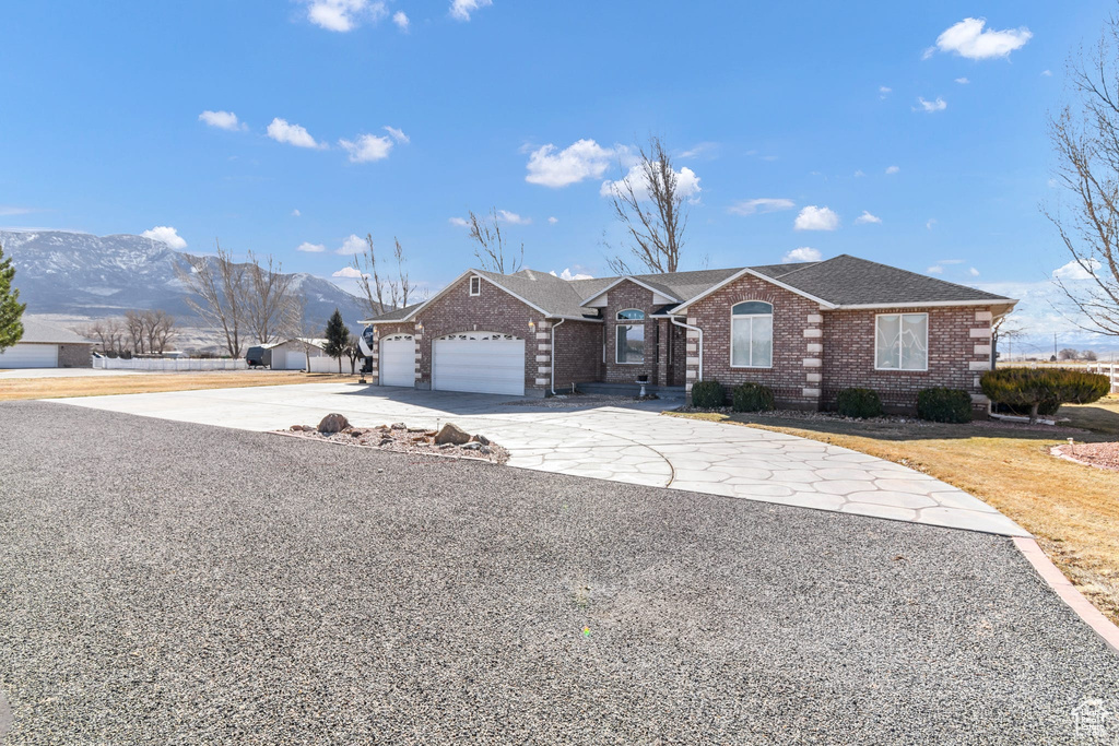 View of front of property featuring a garage and a mountain view