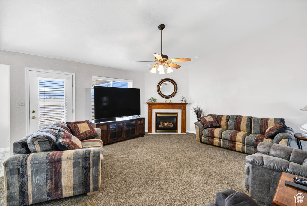 Living room with carpet flooring and ceiling fan