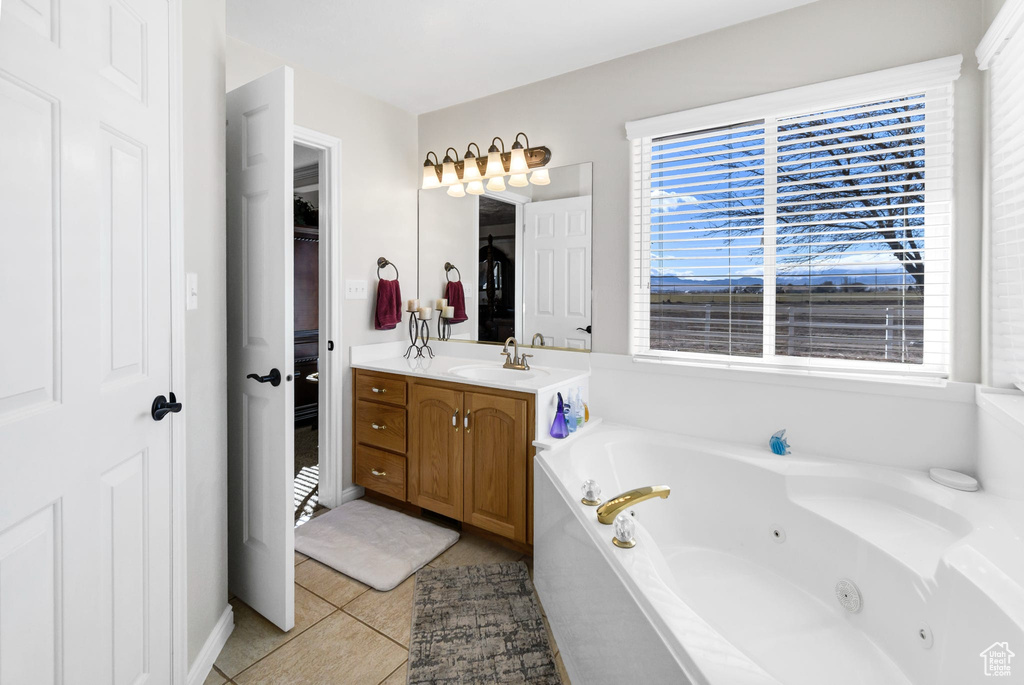 Bathroom with vanity, tile patterned floors, and a bathing tub