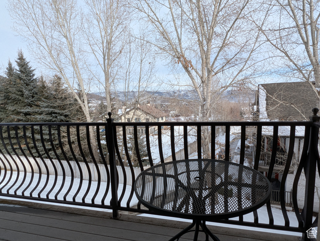 Snow covered back of property with a mountain view