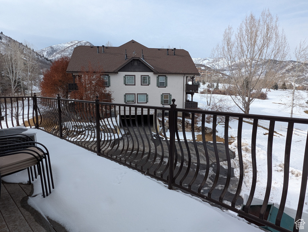 Snow covered deck with a mountain view