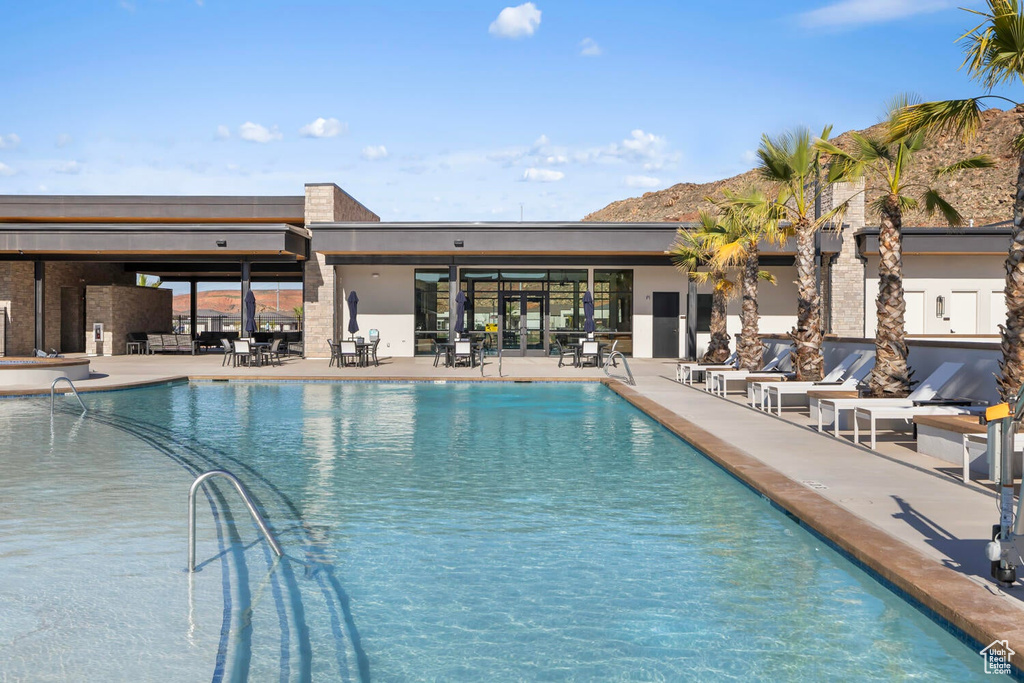 View of pool with a mountain view and a patio