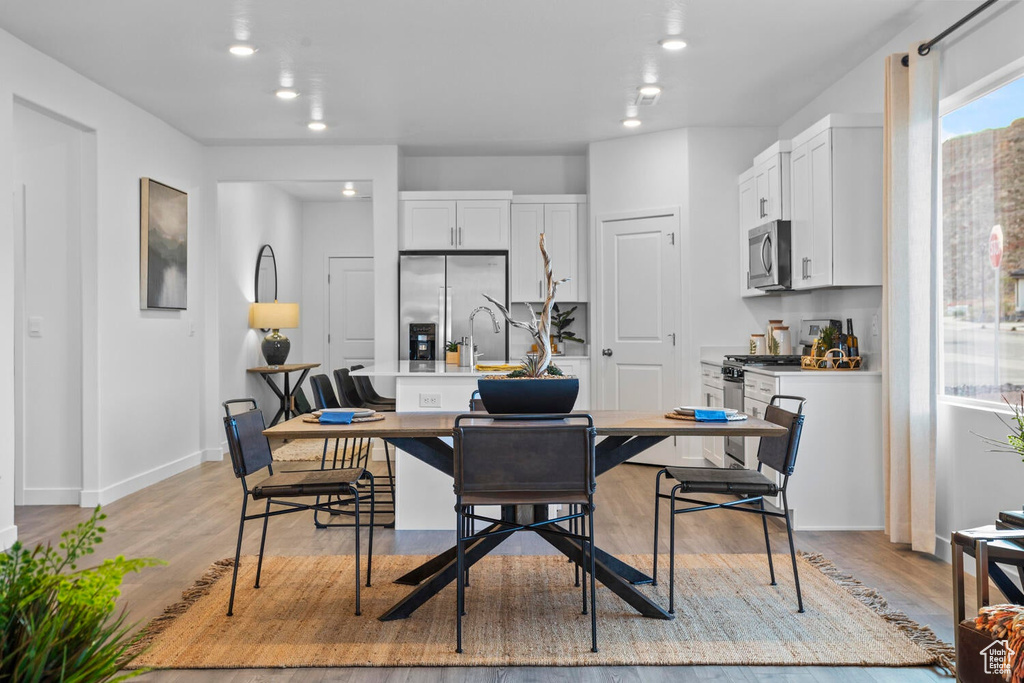 Dining area with light wood-type flooring