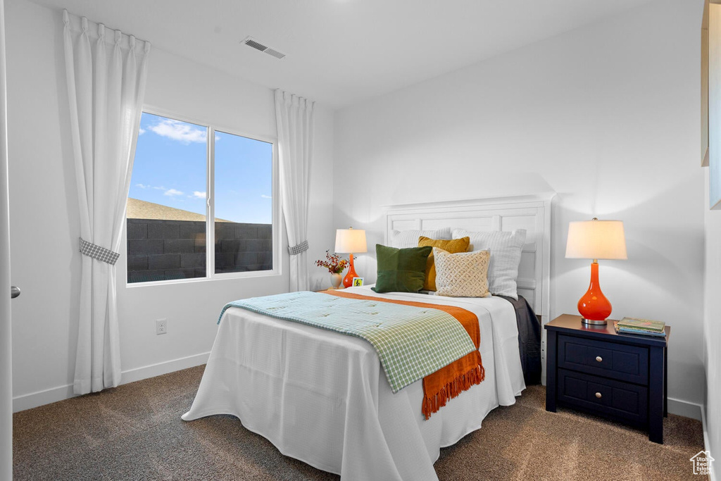 Bedroom featuring dark colored carpet
