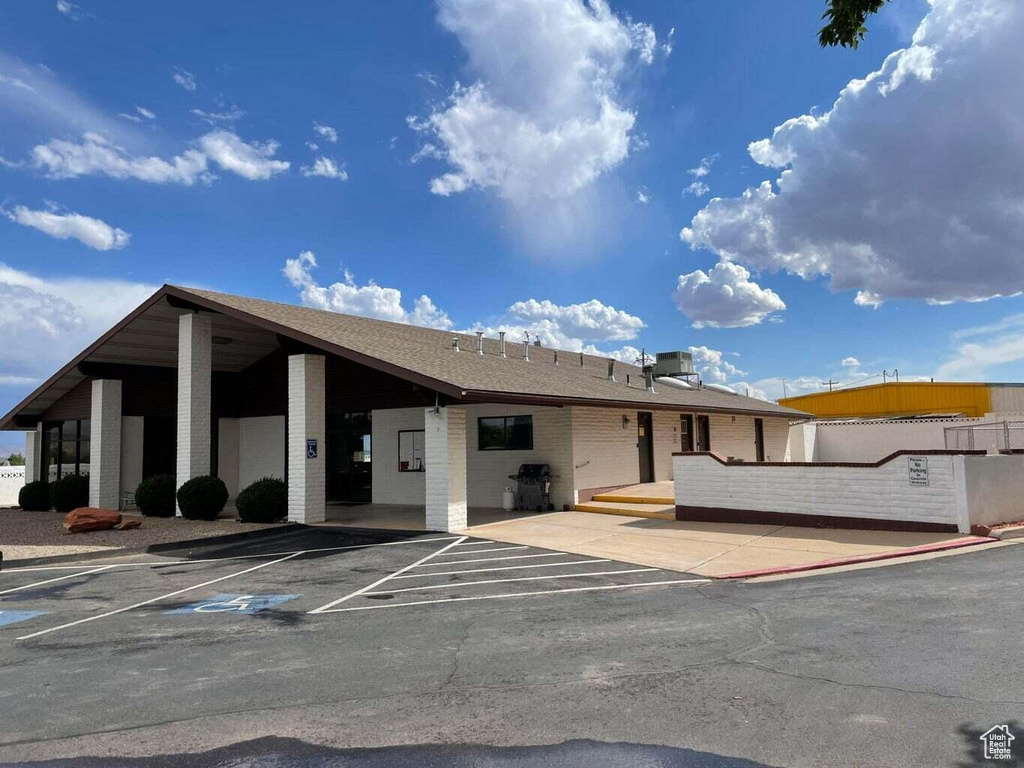 View of property featuring uncovered parking