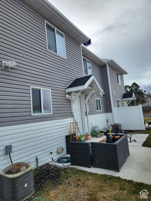 Rear view of property featuring central AC unit, outdoor lounge area, and a patio