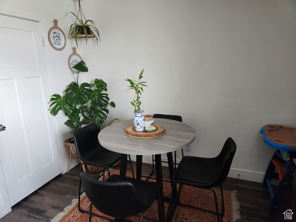 Dining area featuring dark wood-type flooring