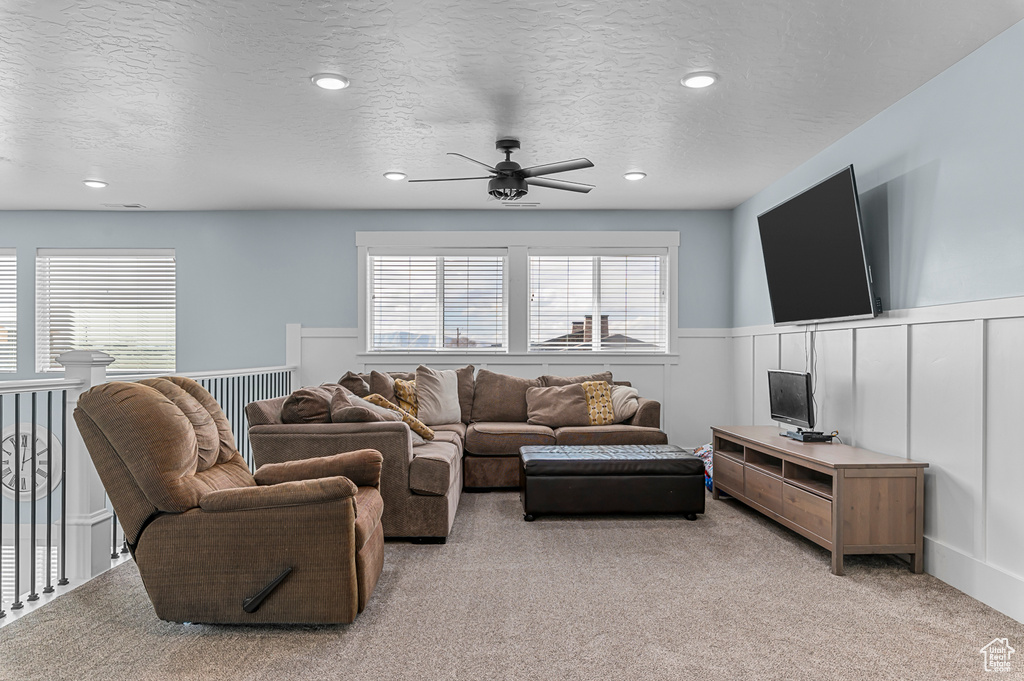 Living room with light carpet and a textured ceiling