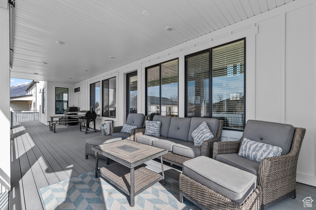 Wooden terrace featuring an outdoor hangout area