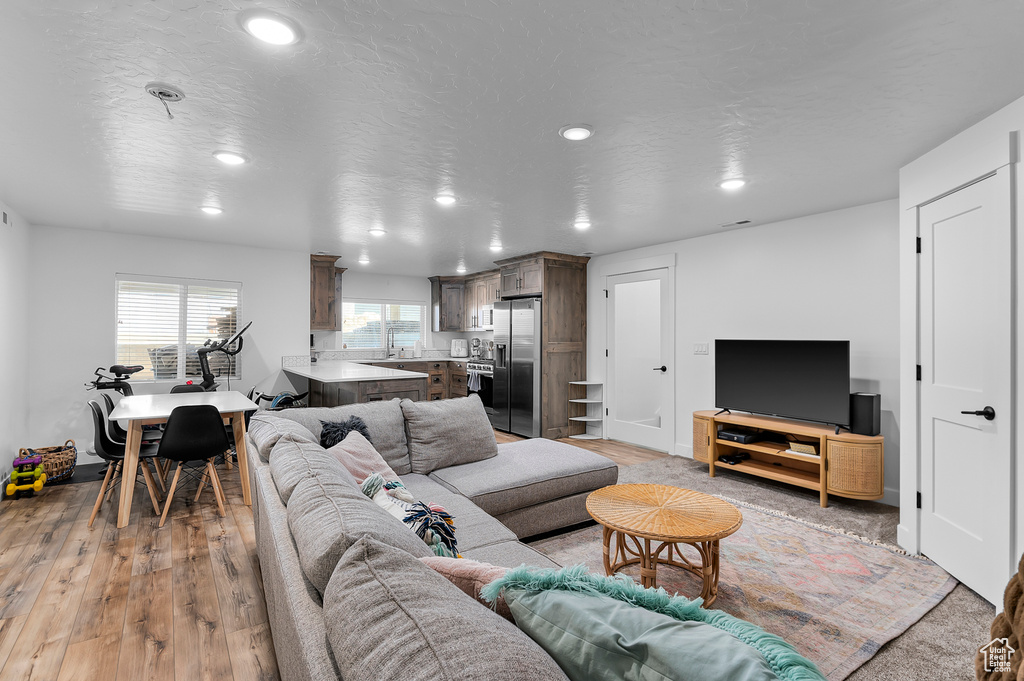 Living room featuring a textured ceiling and light hardwood / wood-style floors