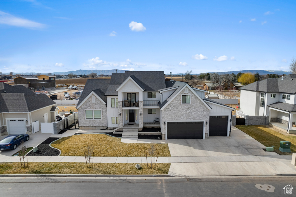 View of front of home with a garage and a mountain view