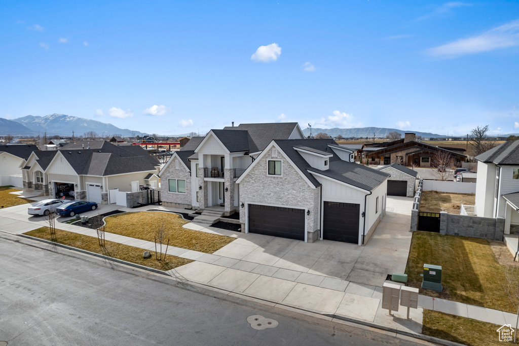 View of front facade featuring a mountain view and a garage