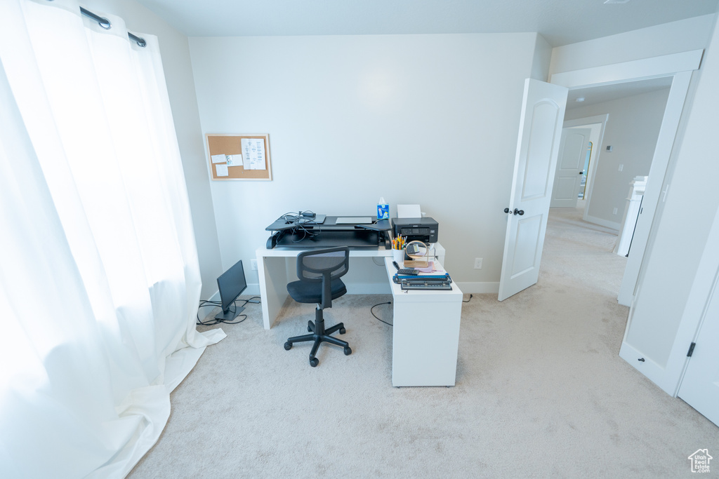 Carpeted office space featuring baseboards
