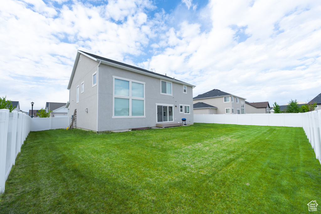 Back of house featuring stucco siding
