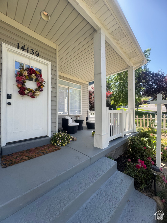 View of exterior entry with a porch