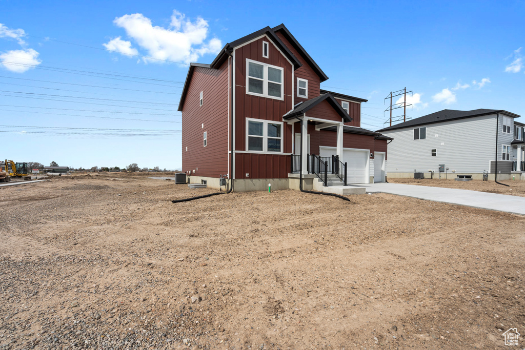 Traditional-style home featuring board and batten siding and concrete driveway