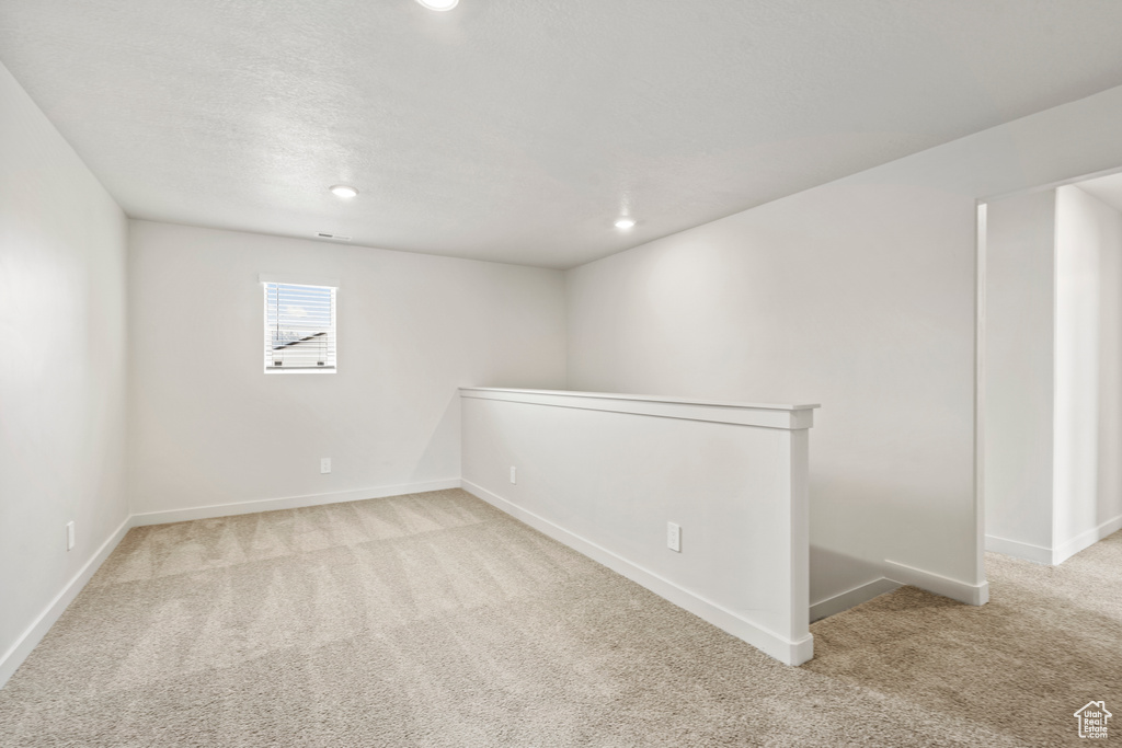 Below grade area featuring carpet, baseboards, and recessed lighting