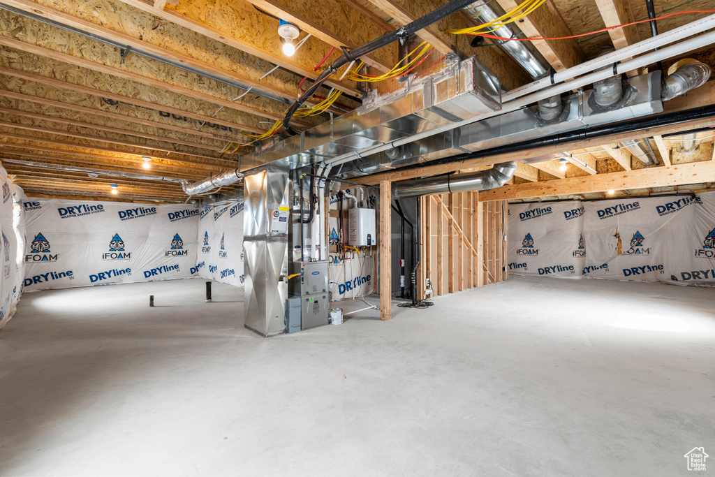 Unfinished below grade area featuring heating unit