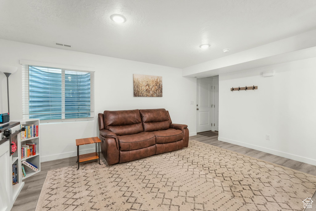 Living room with wood-type flooring and a textured ceiling