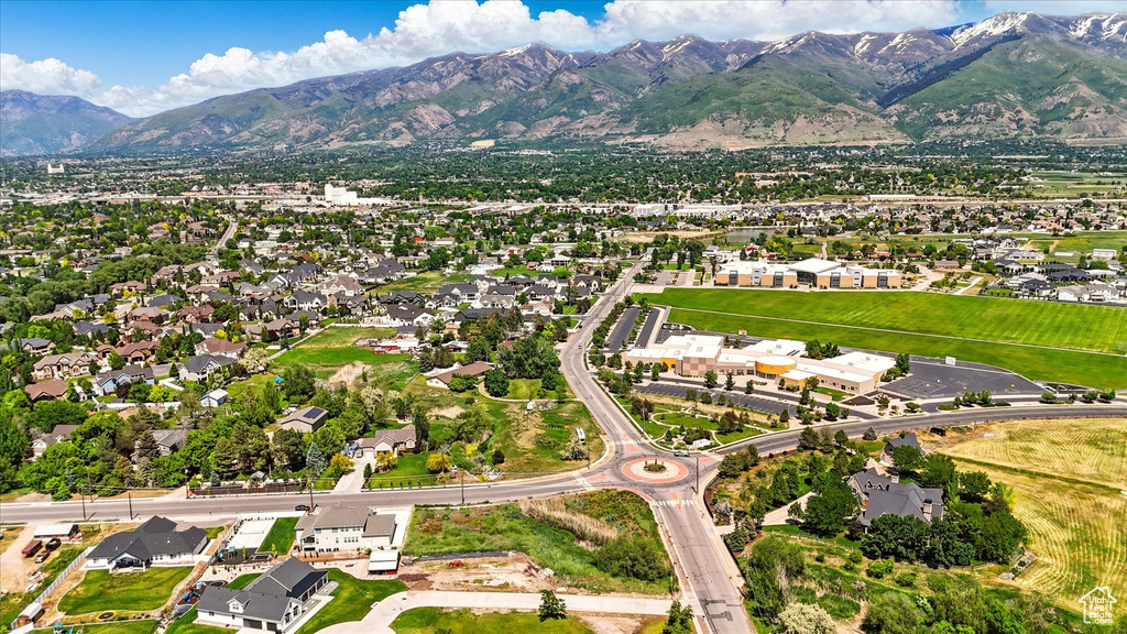 Aerial overview of property's location featuring a mountainous background and nearby suburban area