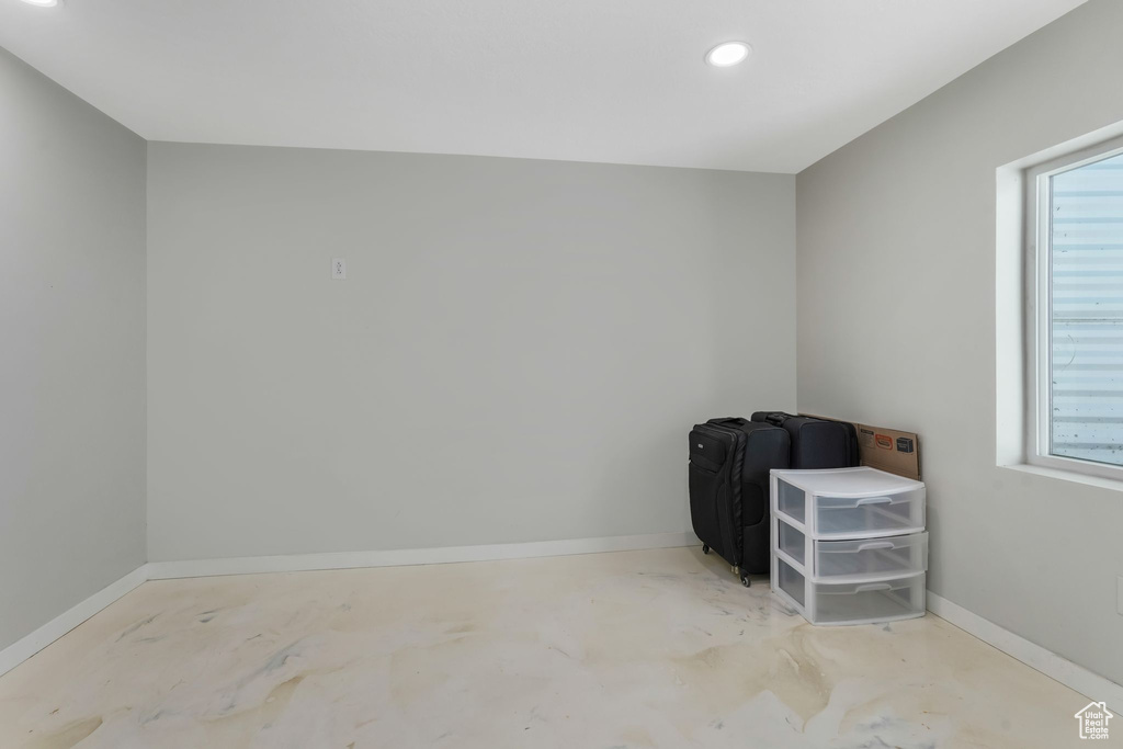 Unfurnished room featuring concrete floors, recessed lighting, and baseboards