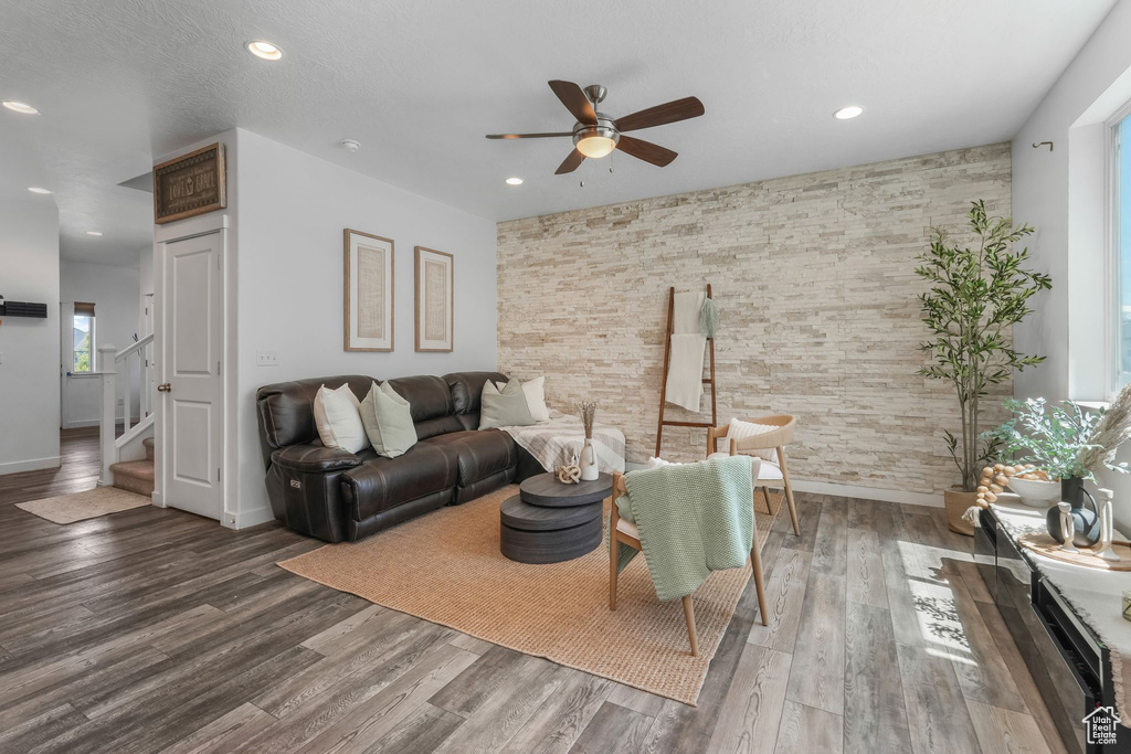 Living room featuring a ceiling fan, recessed lighting, stairs, wood finished floors, and baseboards