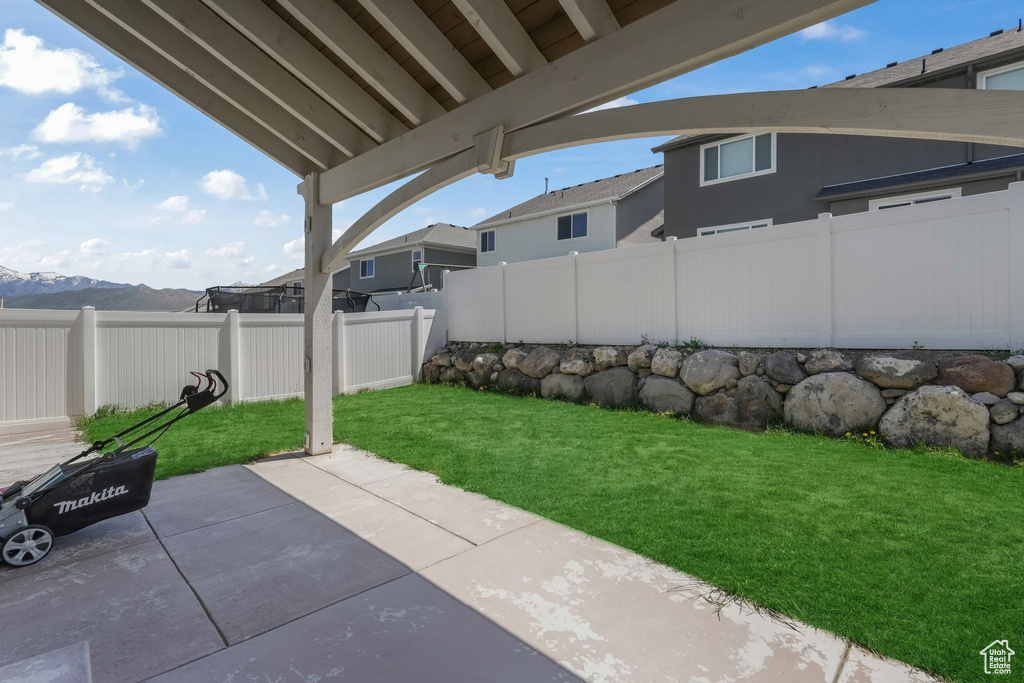 View of yard featuring a patio and a mountain view