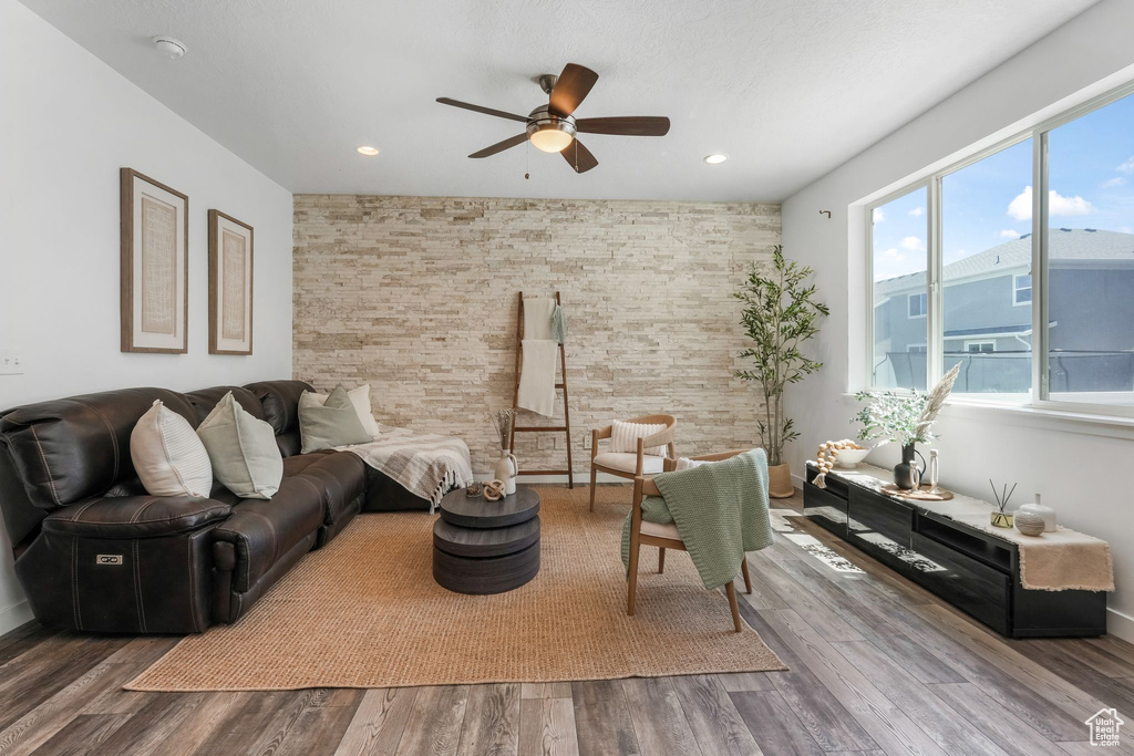 Living area with a ceiling fan, wood finished floors, and recessed lighting
