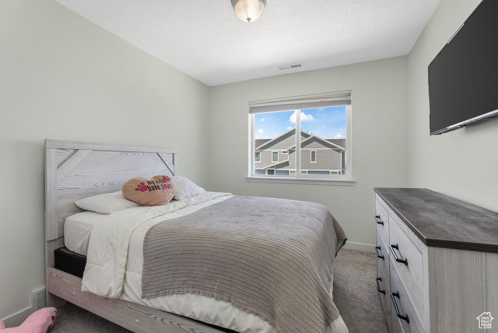 Carpeted bedroom featuring baseboards