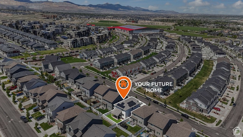 Aerial view of property and surrounding area featuring mountains