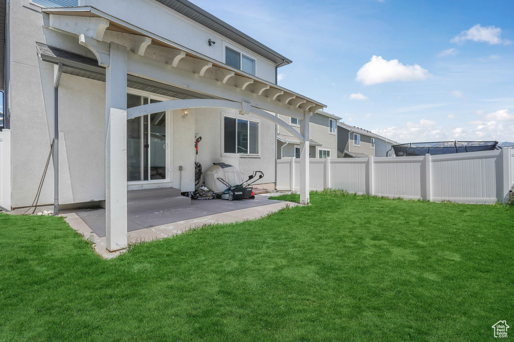 Rear view of house with a patio and stucco siding