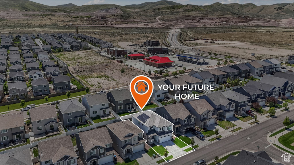 Aerial perspective of suburban area with a mountainous background