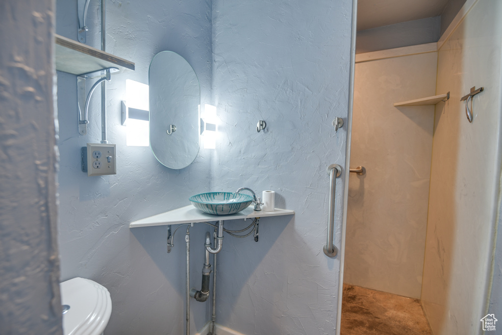 Bathroom featuring concrete flooring and sink