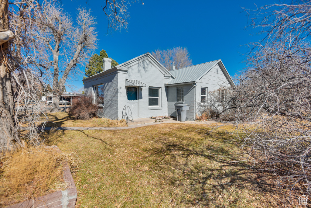 View of property exterior featuring a lawn