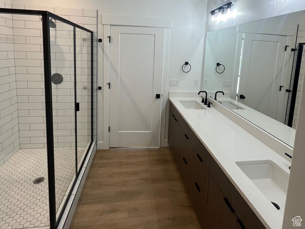 Bathroom with vanity, hardwood / wood-style floors, and walk in shower