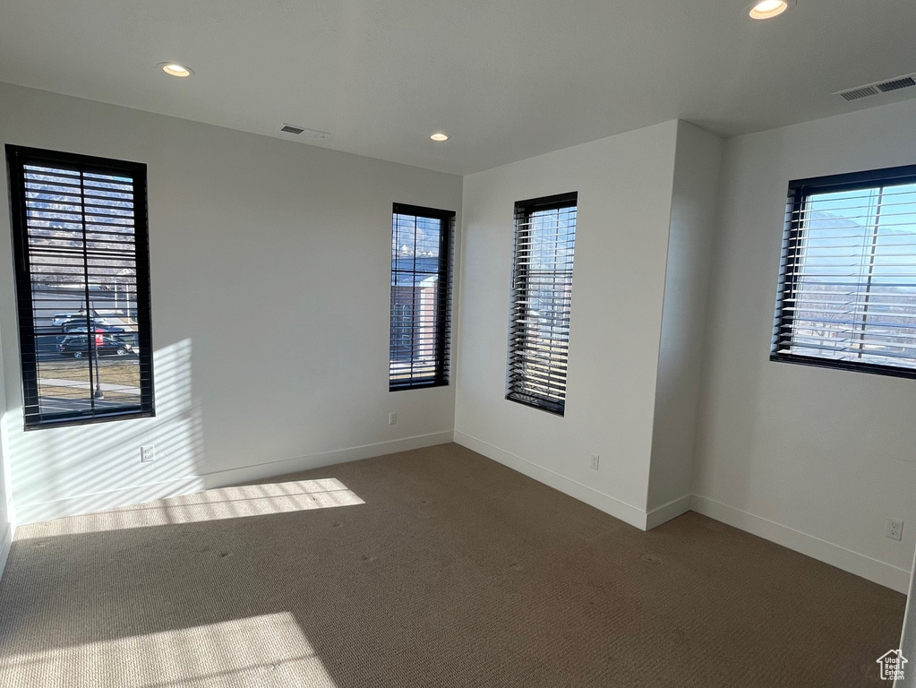 Carpeted empty room with a healthy amount of sunlight