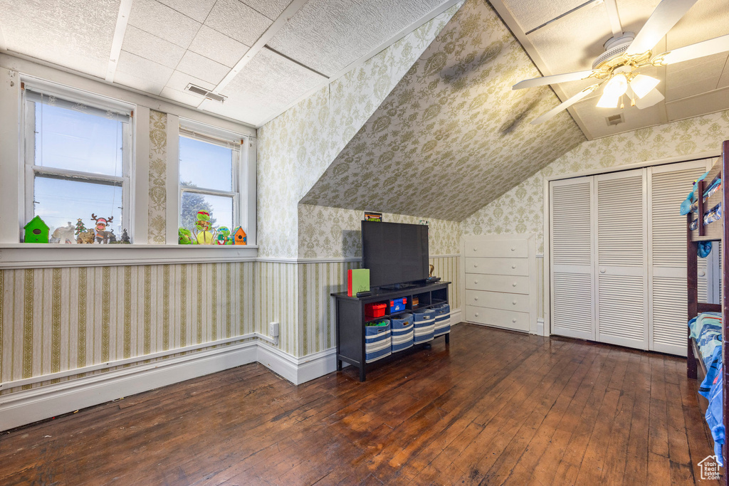 Additional living space featuring dark hardwood / wood-style floors and ceiling fan